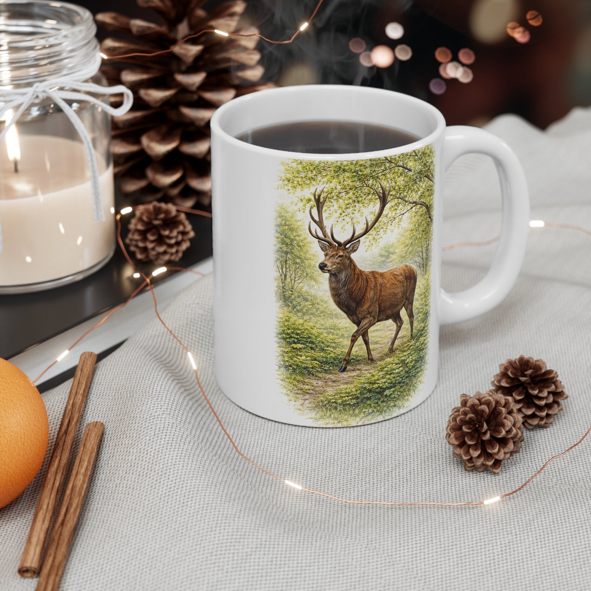 Deer stag illustration mug on table with pinecones, cinnamon sticks and festive decor – wildlife nature gift