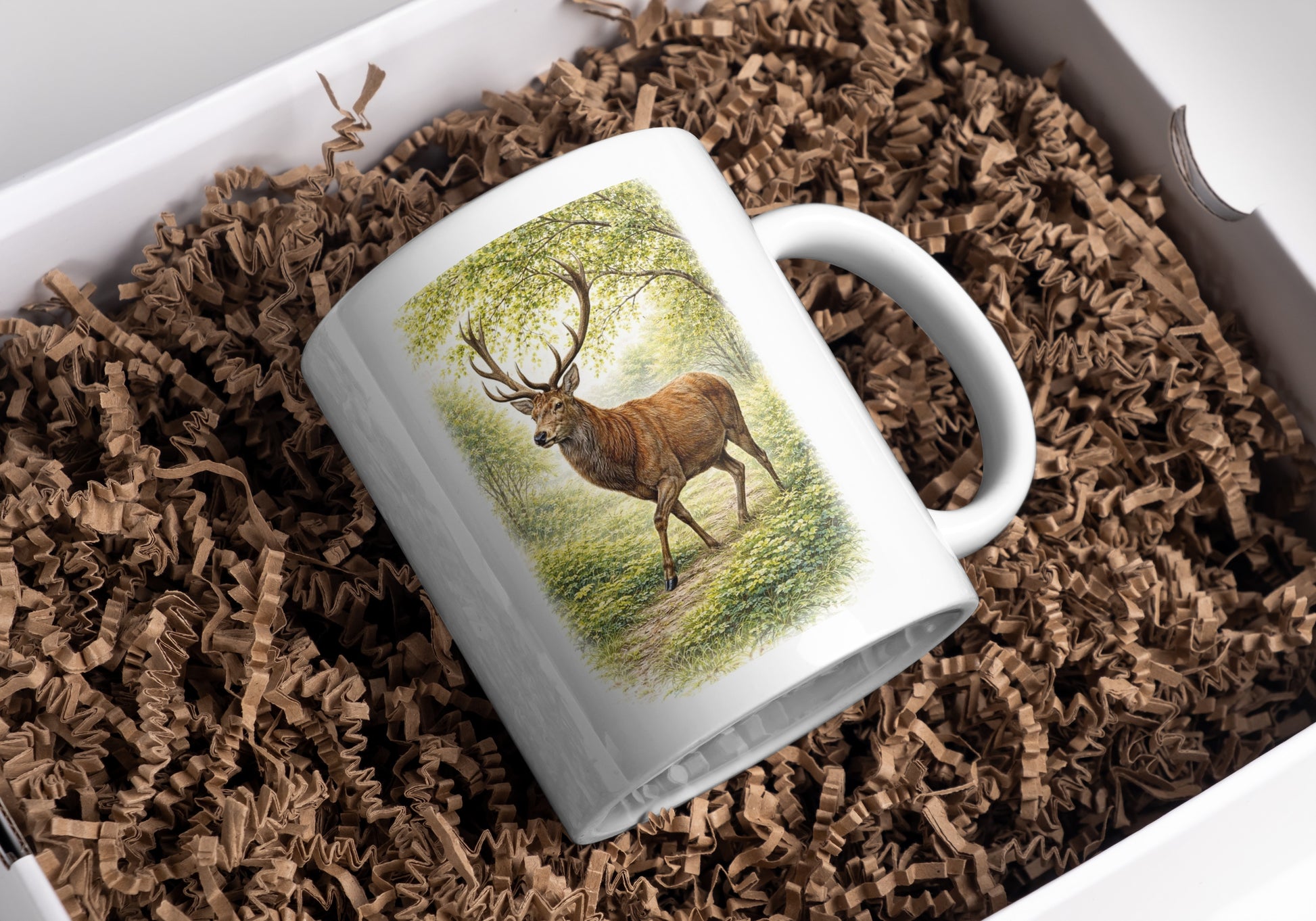 Deer stag mug with forest illustration presented on brown paper shreds packaging – wildlife nature gift